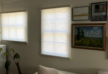Custom sheer roller shades covering large windows in stylish Redwood City living room
