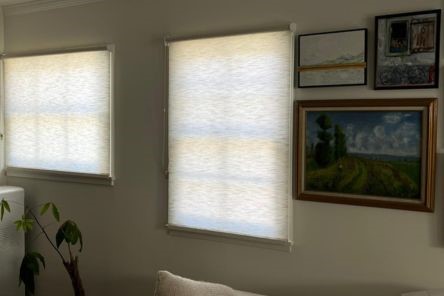 Elegant sheer roller shades and cozy seating area illuminated by natural light in Redwood City home
