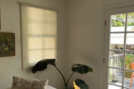 Custom sheer roller shades covering large windows in stylish Redwood City living room